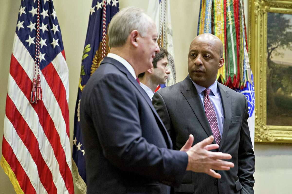 Marvin Ellison, chairman and CEO of J.C. Penney Co., right, talks to Greg Sandfort, CEO of Tractor Supply Co., before a meeting with President Donald Trump.