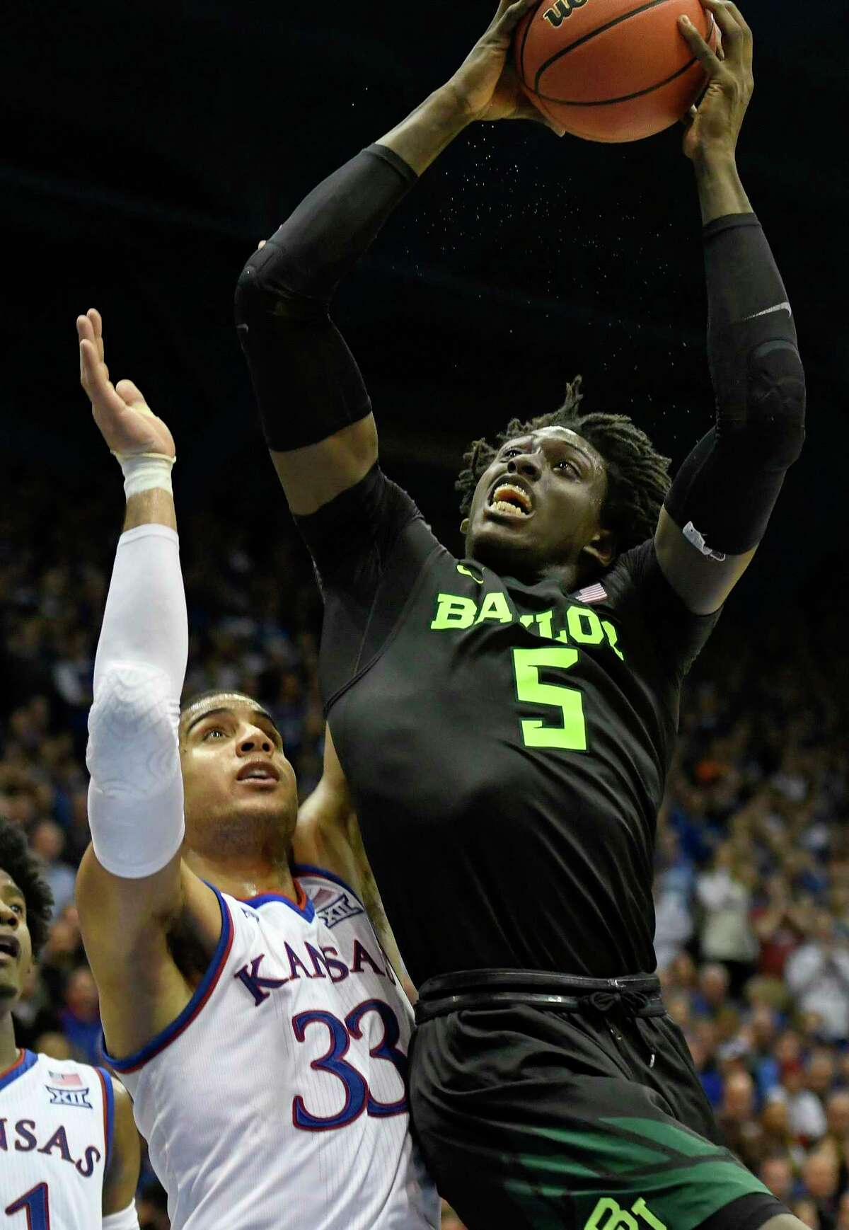 Baylor Bears forward Johnathan Motley (5) goes up for a shot against Kansas Jayhawks forward Landen Lucas (33) during the second half of an NCAA college basketball game in Lawrence, Kan., Wednesday, Feb. 1, 2017. (AP Photo/Reed Hoffmann)