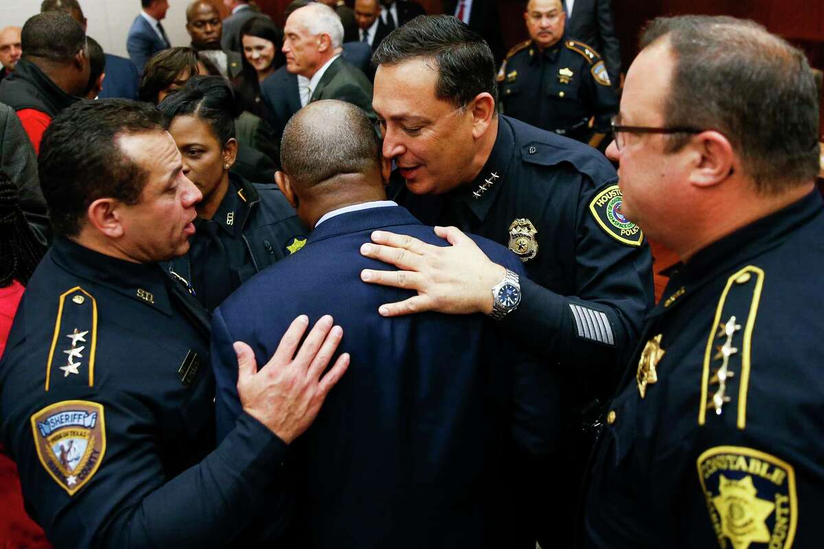 Houston police chief Art Acevedo, second from right, and Harris County sheriff Ed Gonzalez, left, talk to Houston mayor Sylvester Turner, second from left, after Harris County district attorney Kim Ogg announced a new policy to decriminalize low-level possession of marijuana Thursday, Feb. 16, 2017 in Houston. The new policy means that most misdemeanor offenders with less than four ounces of marijuana will not be arrested, ticketed or required to appear in court if they agree to take a four-hour drug education class.