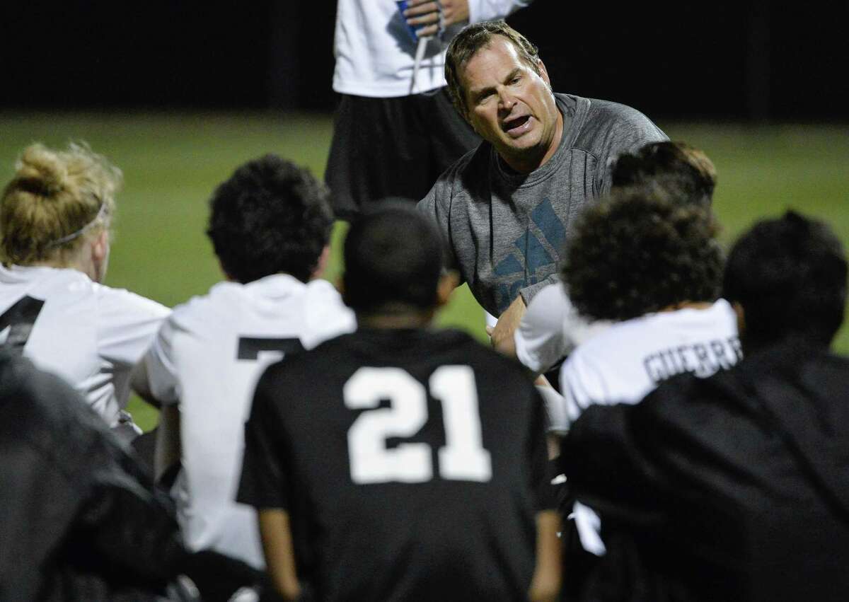 Clark coach Walter Rule talks to his players during halftime of playoff match against Clemens on April 5, 2016, in San Antonio.