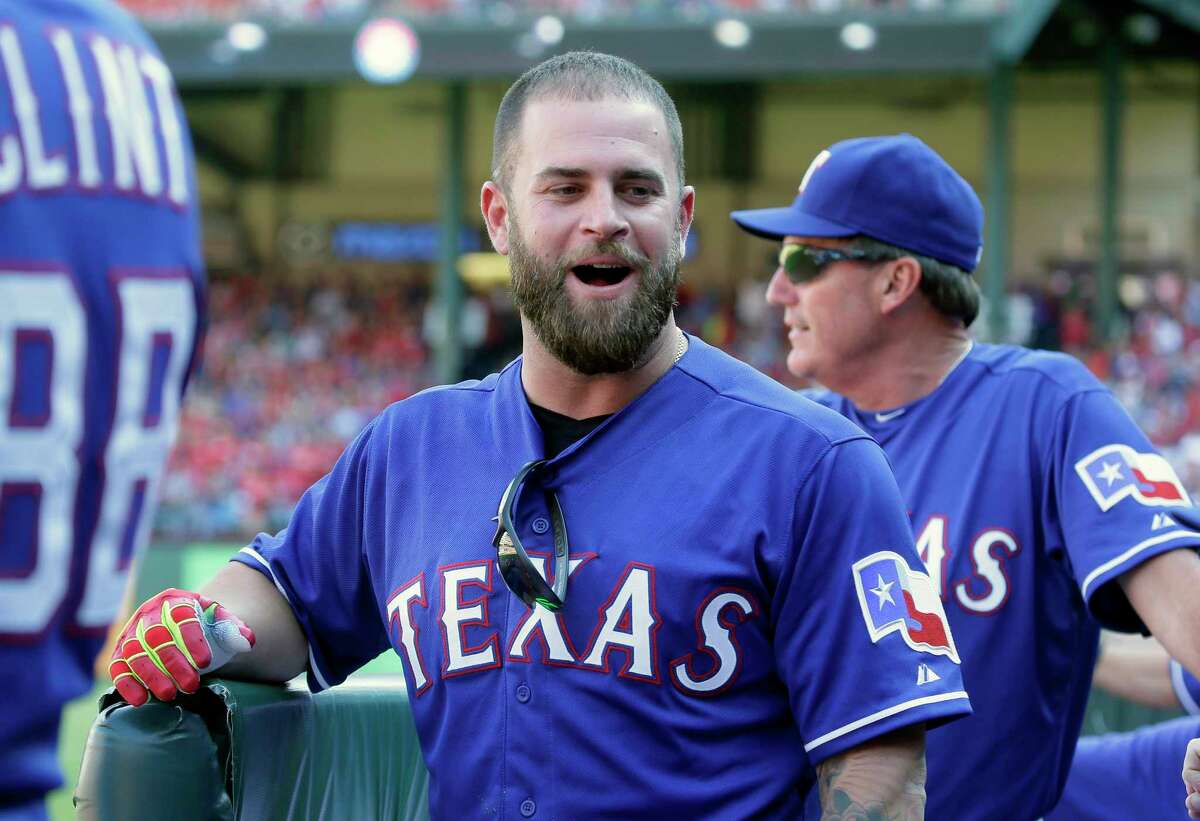 FILE - In this Oct. 4, 2015, file photo, Texas Rangers' Mike Napoli talks with teammates in the dugout during a baseball game in Arlington, Texas. Free agent slugger Mike Napoli and the Cleveland Indians have finalized their $7 million, one-year contract. Napoli had to pass a physical before the deal could be finalized. Napoli can earn an additional $3 million in performance bonuses under Tuesday's, Jan. 5, 2016, agreement. (AP Photo/LM Otero, File)