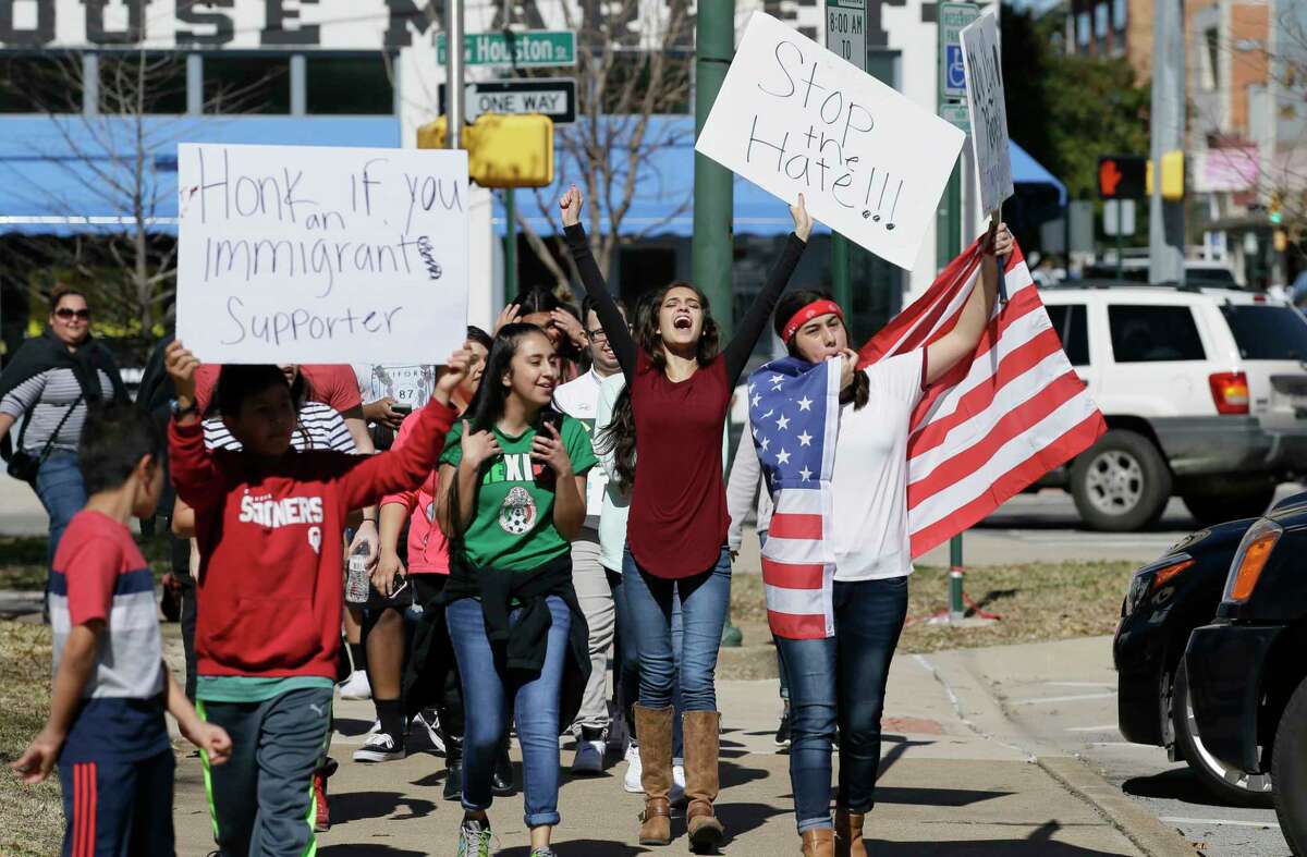Immigrant supporters marches with others during a protest outside the Grayson County courthouse in downtown Sherman, Texas, Thursday, Feb. 16, 2017. In an action called "A Day Without Immigrants," immigrants across the country are expected to stay home from school, work and close businesses to show how critical they are to the U.S. economy and way of life.