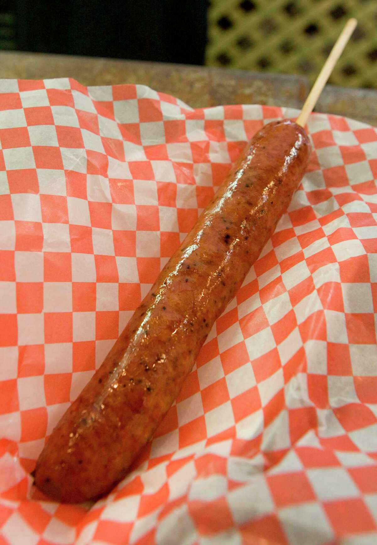 Sausage on a stick from Holmes Smokehouse booth is a popular food item at the Houston Livestock Show and Rodeo. (Friday, March 6, 2009, in Houston. ( Steve Campbell / Houston Chronicle)