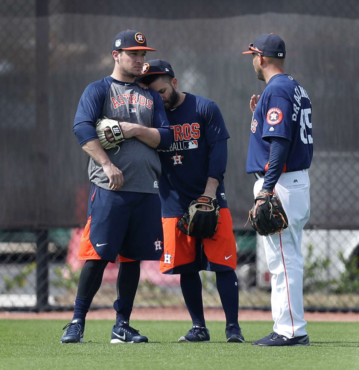 Houston Astros second baseman Jose Altuve leans against Alex Bregman as they chatted with bullpen catcher Javier Bracamonte while they worked out with the other position players who came to camp early during spring training at The Ballpark of the Palm Beaches, in West Palm Beach, Florida, Thursday, February 16, 2017.