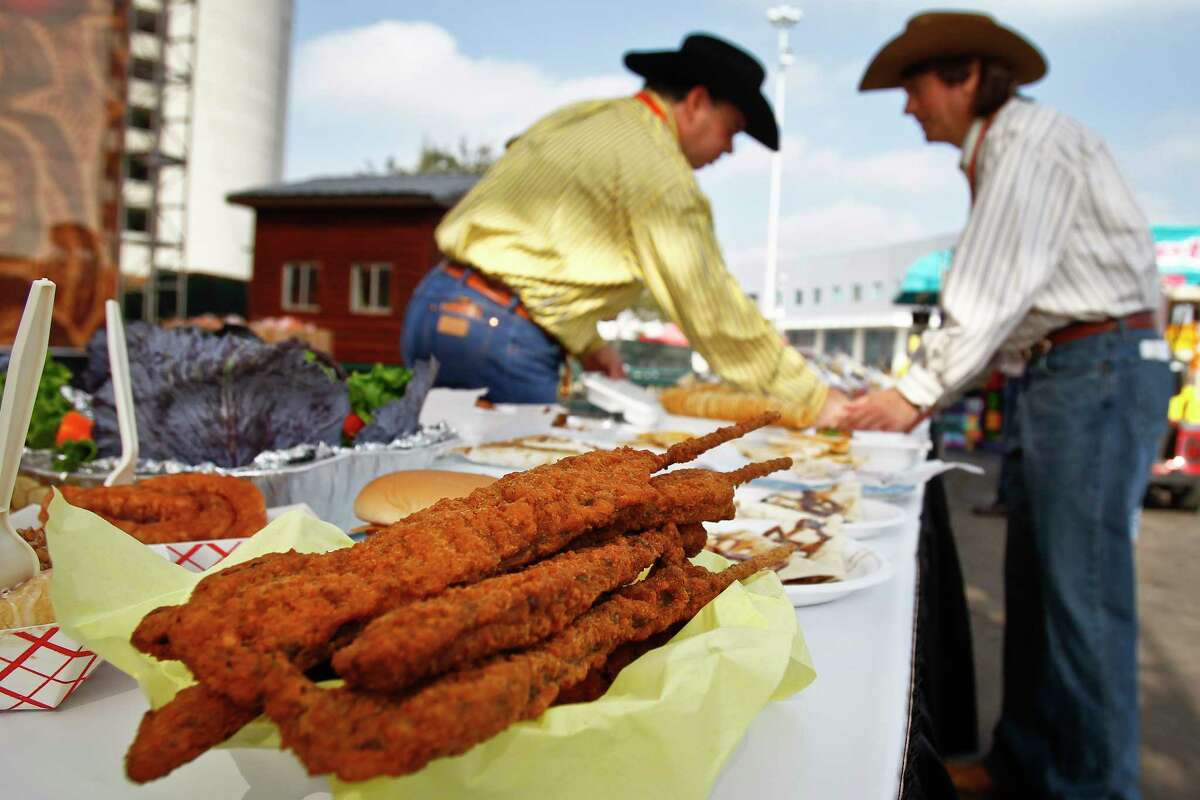 Fried beef kerky from Yoakum Packing Company sits on the table as Jay Justilian (left) and John Kaplan (all with the Commercial Exhibits Committee) organize entered food during the 3rd Annual Gold Buckle Foodie Awards at the Houston Livestock Show and Rodeo.
