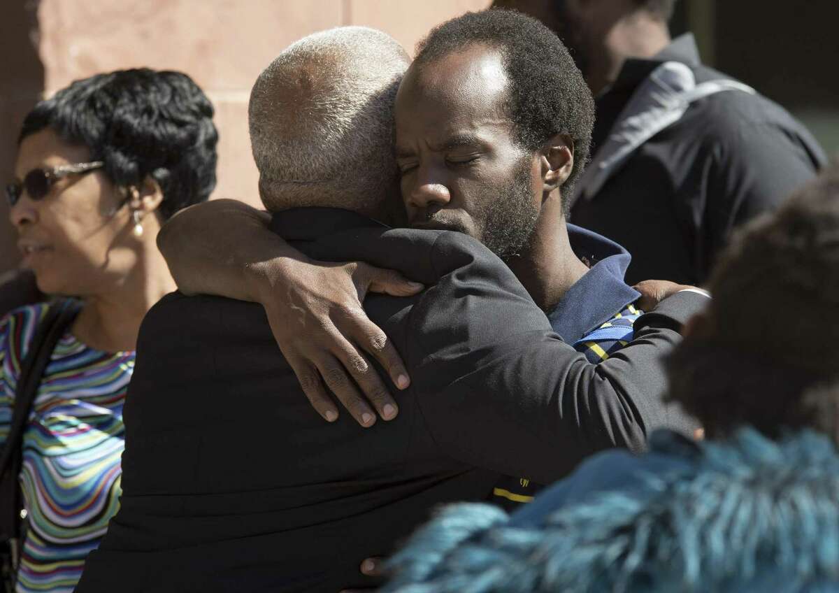 Kalion Busby, right, brother of Qwalion Busby, hugs his father, Ernest Busby, after the punishment phase of the trial Feb. 16 of Qwalion Busby and Marquita Johnson, who were convicted of injury to a child by omission in regard to the death of their infant son in 2015.