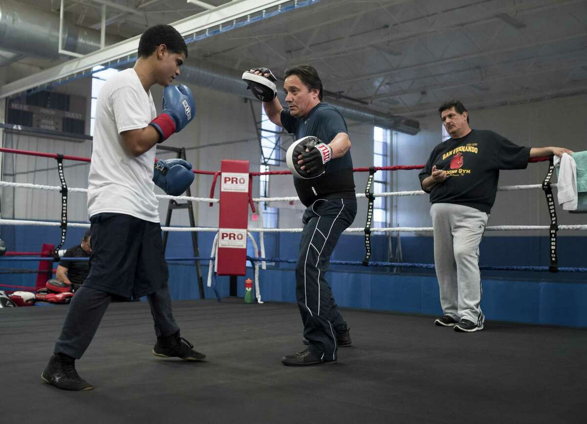 Jesse Cantu, center, works out with Carlos Tejeda, left, and Orlando Mendiola at Lincoln Community Center, Tuesday, Feb. 14, 2017, in San Antonio.