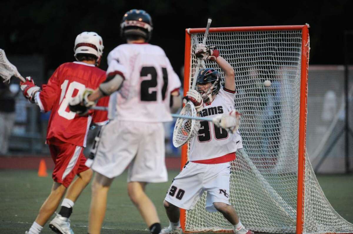 New Canaan golaie Thomas Carey, right, can not stop a 2nd quarter goal by Greenwich High School's Pete Cabrera (not in photo), during 2nd quarter action of the FCIAC Lacrosse Championship at Brien McMahon High School, Norwalk, Friday, May, 28, 2010. At left is Eric Foote of GHS, #18, looking on. The score at the half is 5-1 GHS over NC.