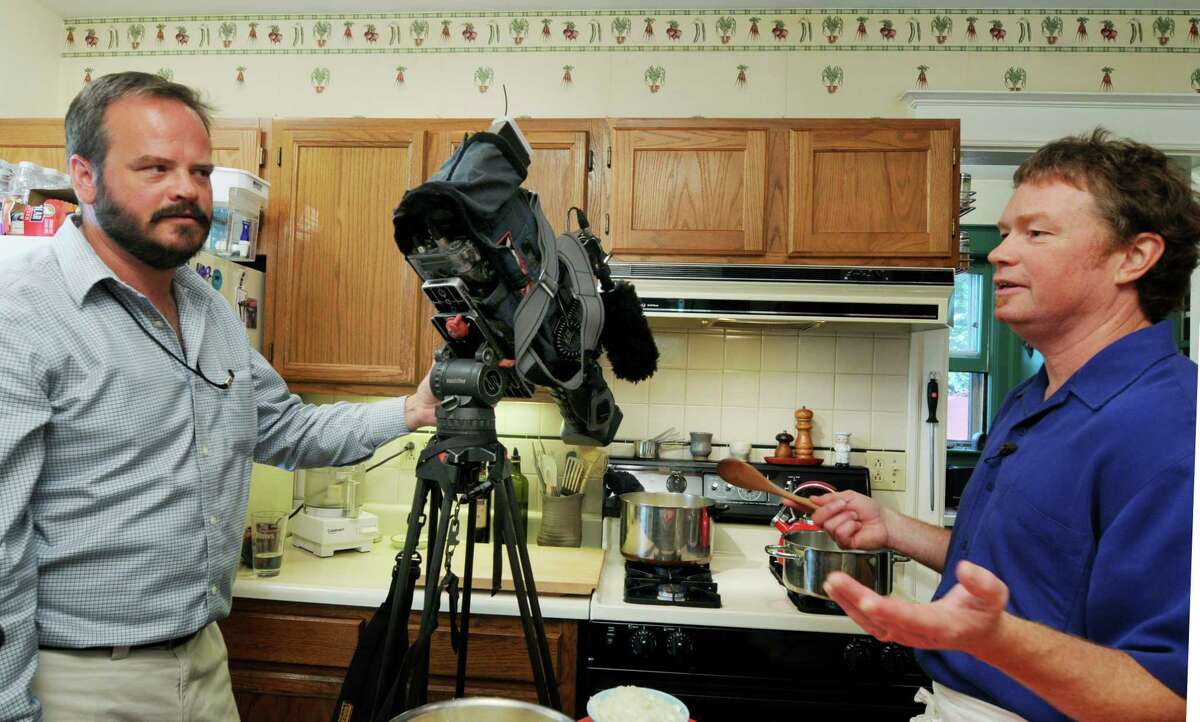 Photojournalist Chris Coffey, left, with "Cooking At Home" chef and host Dan Eaton in the kitchen of Eaton's Rochester, NY, home on Tuesday, June 29, 2010, a taping day for his cooking show on Time Warner Cable News (Luanne M. Ferris/Times Union)
