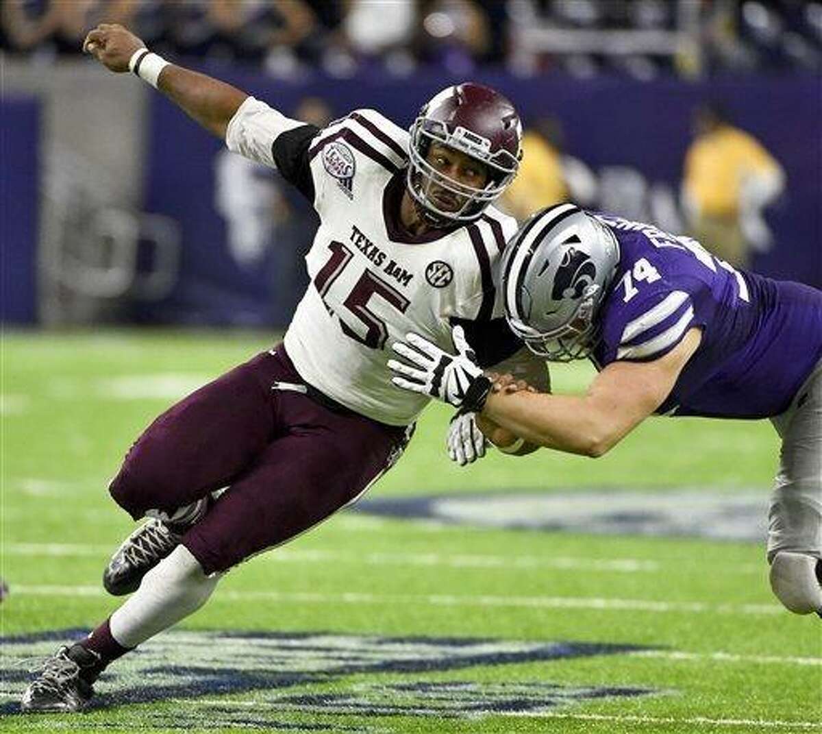 FILE - In this Dec. 28, 2016, file photo, Texas A&M's Myles Garrett (15) tries to get around Kansas State offensive lineman Scott Frantz during the second half of the Texas Bowl NCAA college football game in Houston. Garrett is among the top prospects in the upcoming NFL draft. (AP Photo/Eric Christian Smith, File)