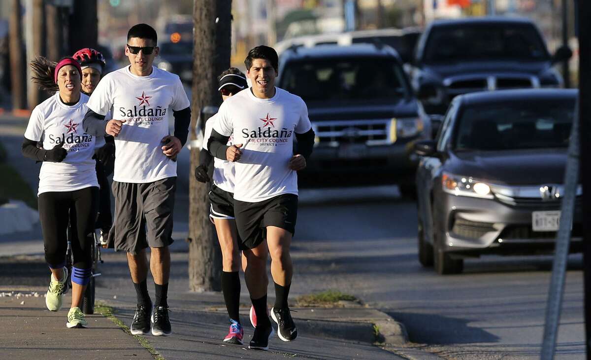 District four city councilman Rey Saldana (front, right) runs Thursday February 16, 2017 with a group of supporters down Zarzamora street. Saldana has made a tradition of running from his Southwest Side district to City Hall each election cycle to file for a place on the ballot in the May 6 election. He's running for his fourth term in office.
