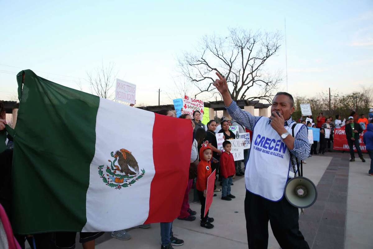 Theodore Aguiluz, Executive Director of Centro de Recursos Centroamericanos, leads the rally with a megaphone at the "Day Without Immigrants" protest at TGuadalupe Plaza on Thursday, February 16, in Houston.