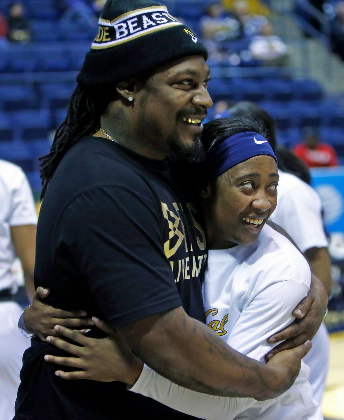 Marshawn Lynch hugs California's Asha Thomas before the Golden Bears played Stanford during PAC 12 women's basketball game at Haas Pavilion in Berkeley, Calif., on Thursday, February 16, 2017.