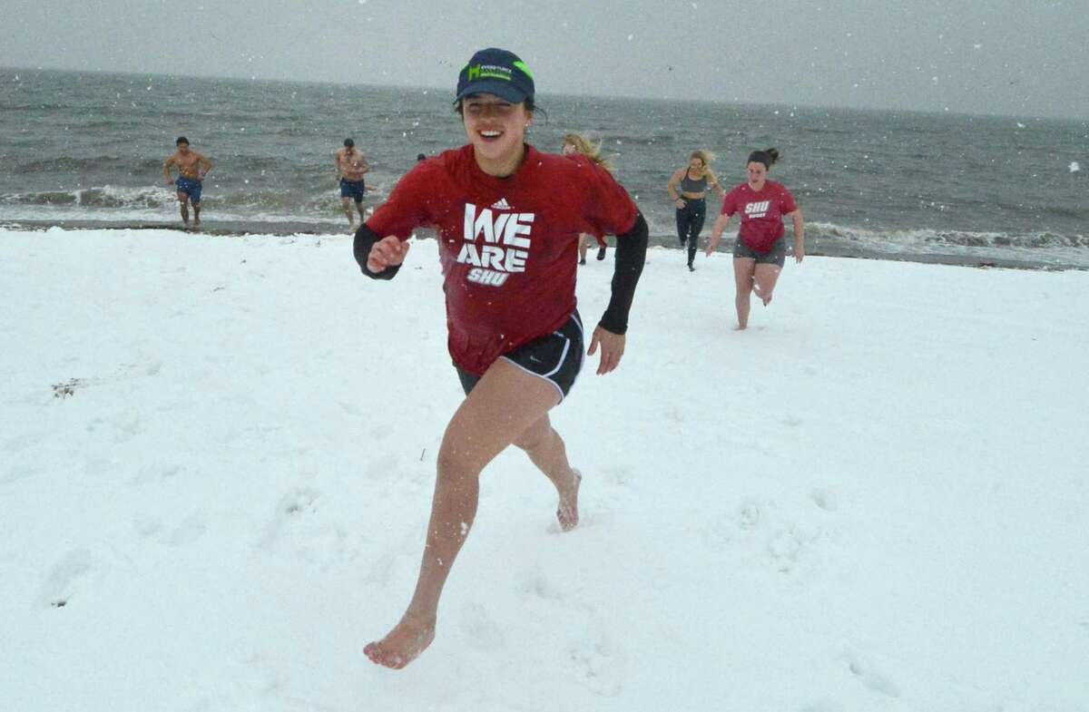 Allie Rinaldi, along with others from the Sacred Heart University Women’s Rugby Team, takes part in National Legacy Group's 2nd Annual Rugger Plunge on Feb. 12 at Penfield Beach. With Long Island Sound water temperatures at 36 degrees and blowing snow, about 50 people made the plunge for charity.