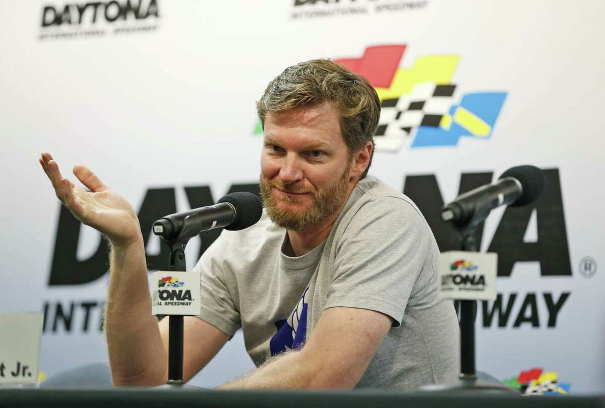 Dale Earnhardt Jr. gestures as he speaks during a news conference before the start of a NASCAR Sprint Cup auto racing practice at Daytona International Speedway, in Daytona Beach, Fla., on June 30, 2016. NASCAR has a new sponsor, a new format and a familiar face this year in its bid to rebound from declining ratings and attendance. The next 11 months will show if Dale Earnhardt Jr., Monster Energy and different rules can provide the needed jolt.
