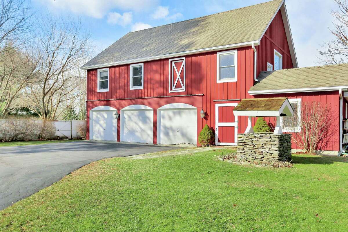 The property features a large red two-story barn, which contains three vehicle bays as well as two over-sized box stalls, tack room, feed room, hay loft, bathroom and a “party room” on the upper level.