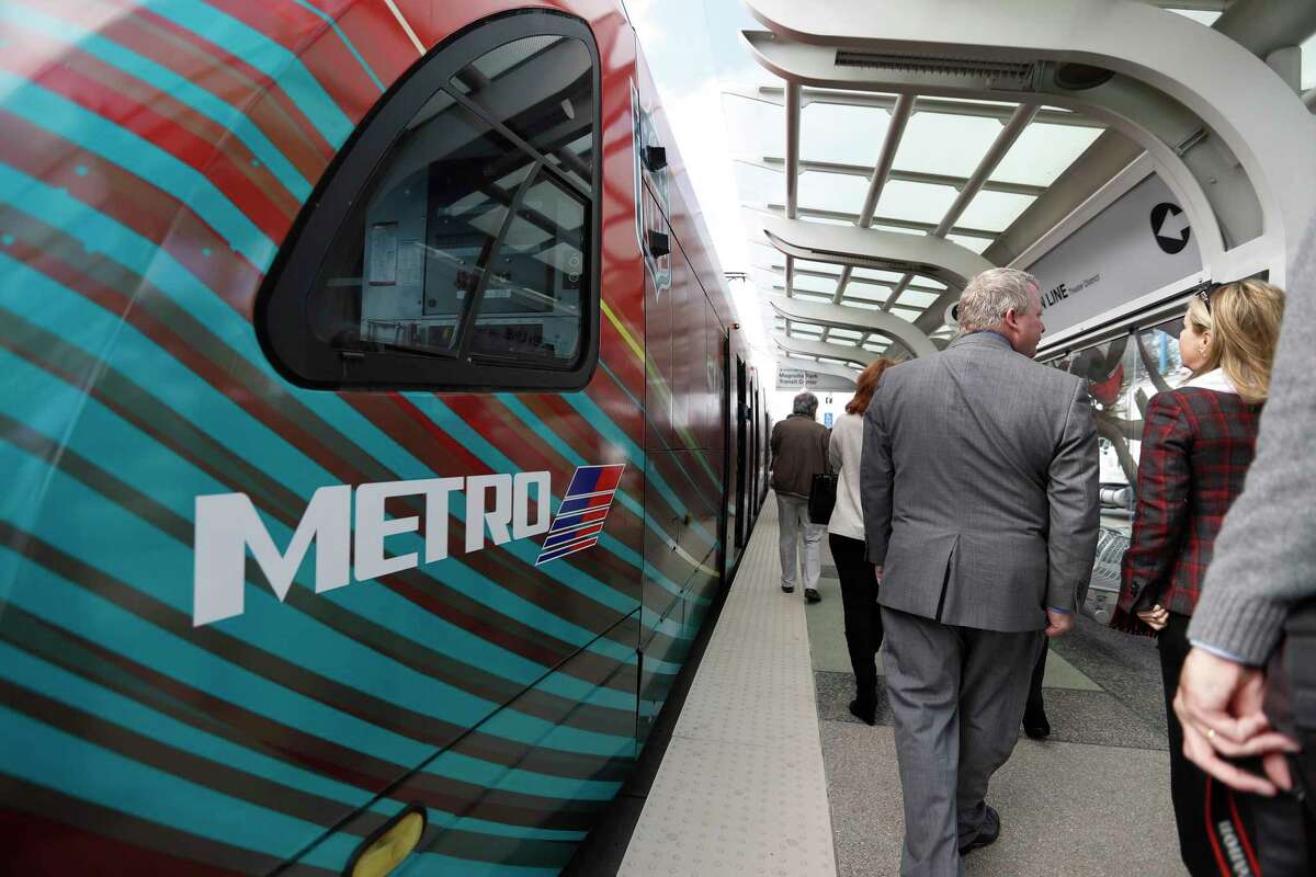 Passengers, including Metropolitan Transit Authority board members and senior staff, disembark after the inaugural Metro train took its first passengers across the recently-completed Harrisburg overpass on Jan. 9.