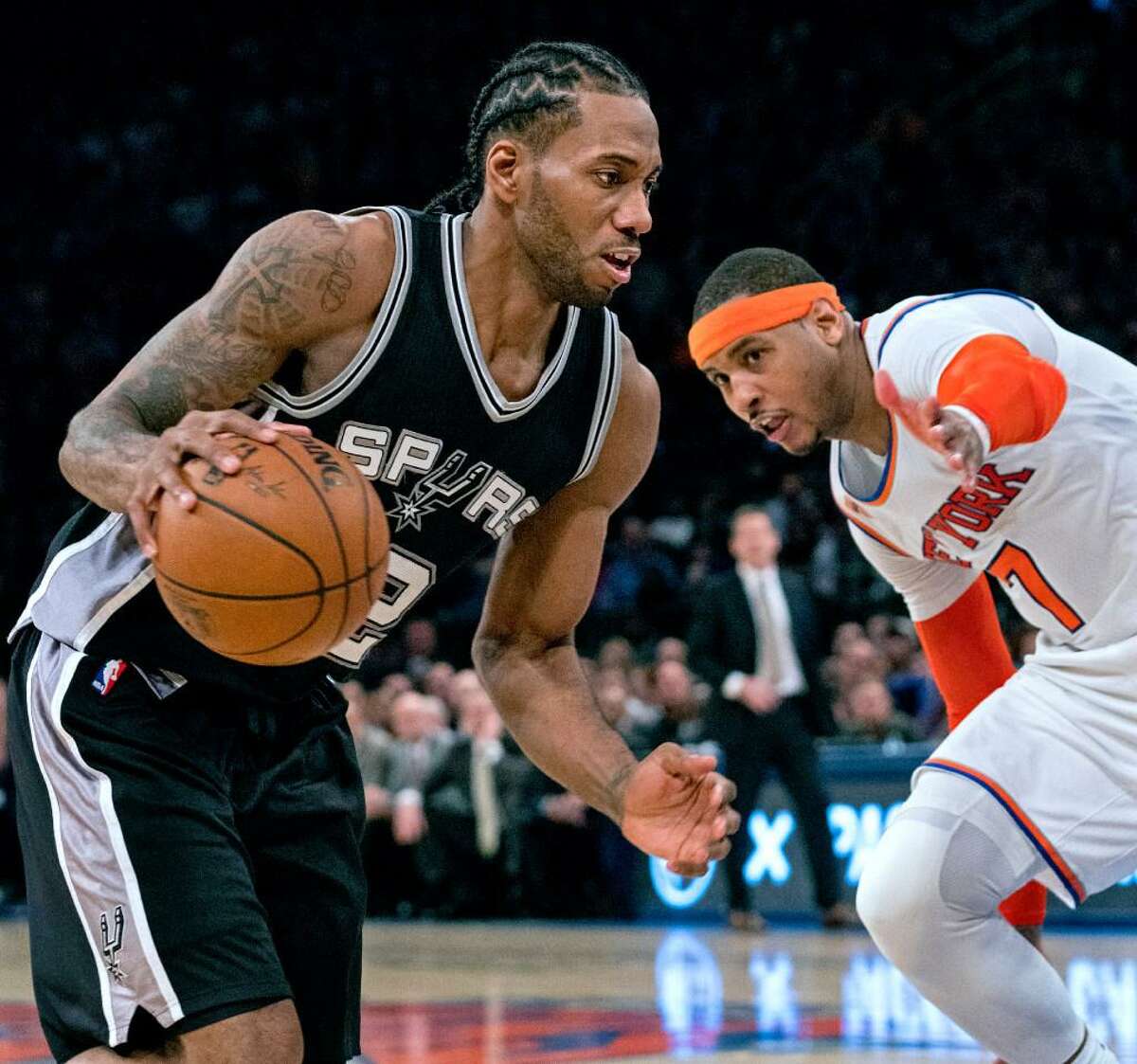 San Antonio Spurs forward Kawhi Leonard, left, drives to the basket past New York Knicks forward Carmelo Anthony in the second half of an NBA basketball game at Madison Square Garden in New York, Sunday, Feb. 12, 2017.