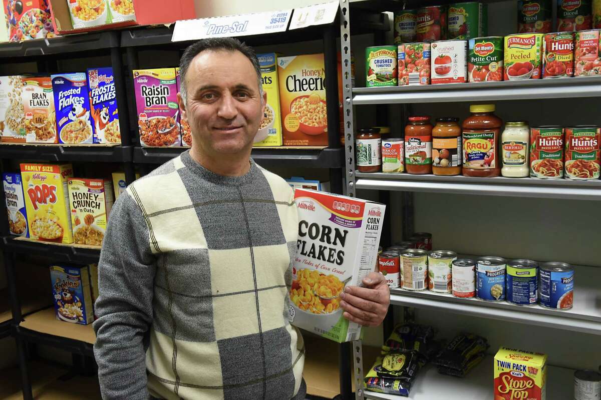 Ayman Akari stands in front of the newly established food pantry at the Muslim Community Center on Thursday, Feb. 16, 2017 in Colonie, N.Y. The pantry will be open to serve needy members on the second Saturday of every month.(Lori Van Buren / Times Union)