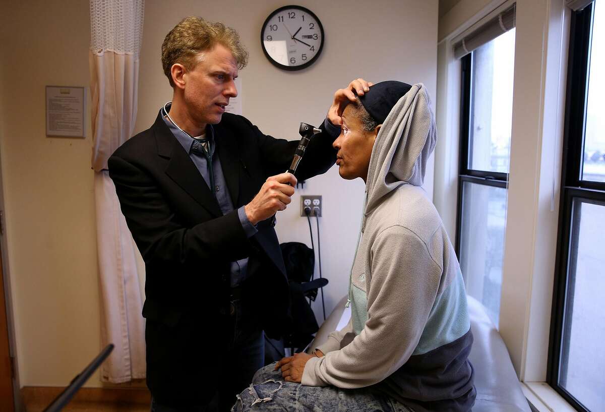 From right: Sonia Hernandez gets her eyes checked by doctor Andrew Desruisseau at the Tenderloin Health Services on Friday, Feb. 17, 2017, in San Francisco, Calif. Hernandez is a Hepatitis C patient.