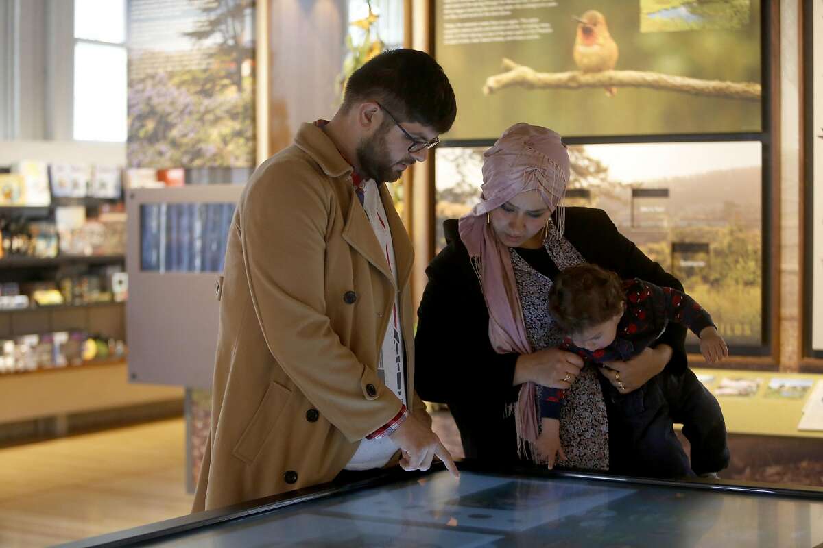 Mikayil Tokdemir, left, looks at an interactive touch screen with his wife, Fatmagul, and his son Ahmet on Friday, Feb. 17, 2017, in San Francisco, Calif.