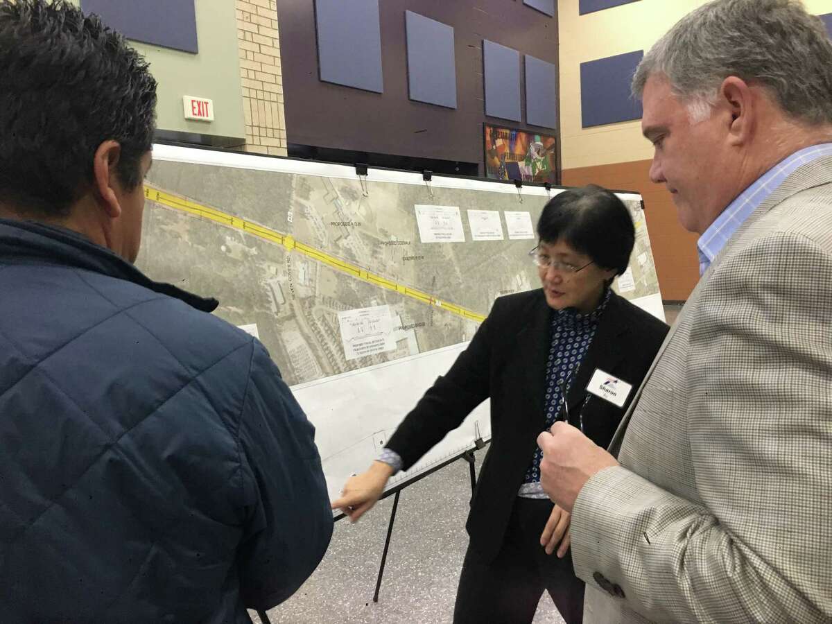 Texas Department of Transportation representative Susan Xu addresses questions Girl Scouts of San Jacinto Council Chair of Properties Committee Van Martin has regarding a proposed $57 million project to widen Texas 75 at a public hearing Thursday at Willis High School.