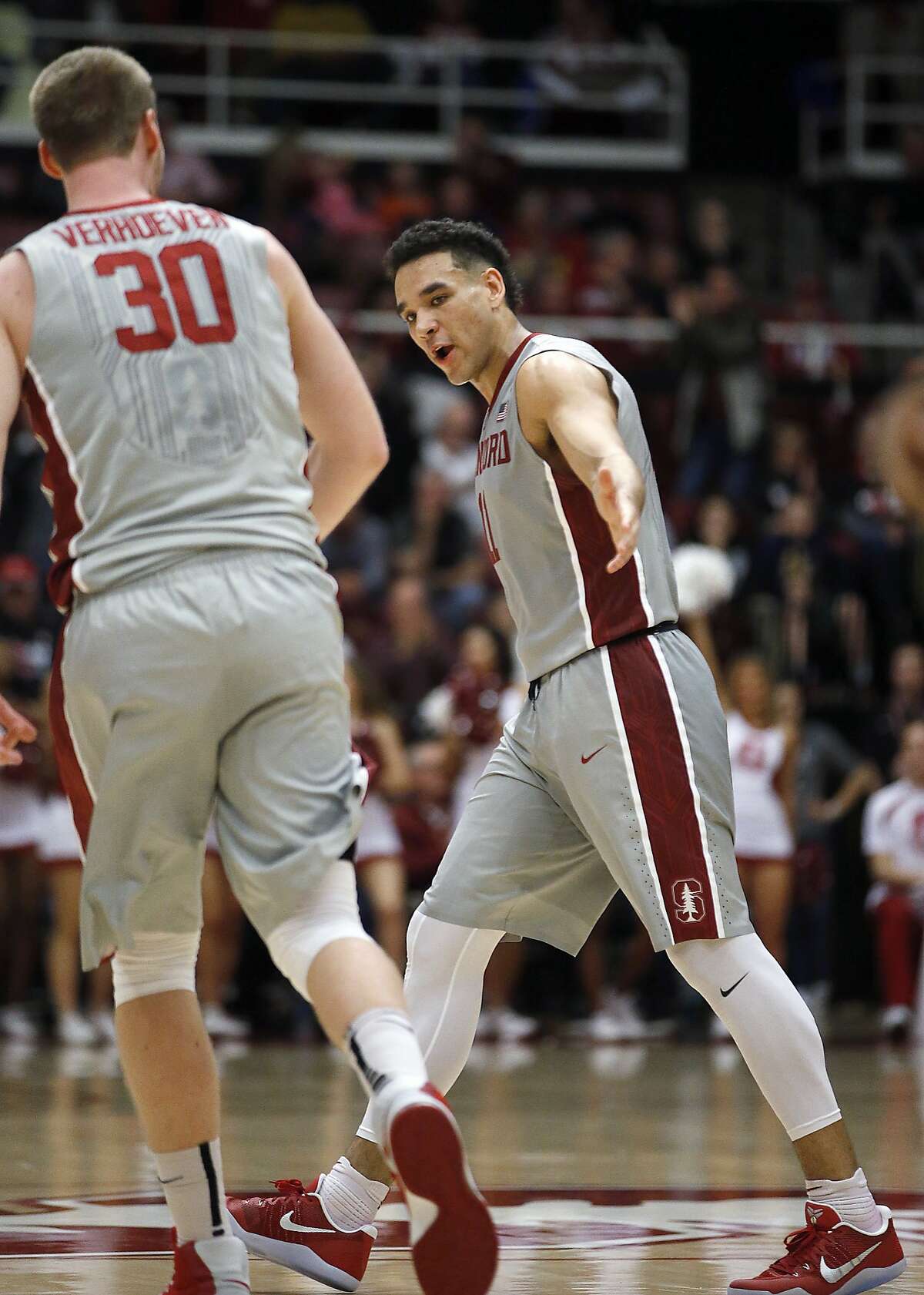 Stanford guard Dorian Pickens, right, celebrates with Grant Verhoeven (30) after scoring a 3-point shot against California during the second half of an NCAA college basketball game Friday, Feb. 17, 2017, in Stanford, Calif. Stanford won 73-68. (AP Photo/Tony Avelar)