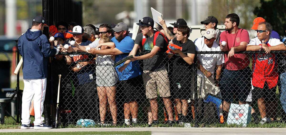 Houston Astros third baseman Alex Bregman (2) signs autographs for fans along the fence during spring training at The Ballpark of the Palm Beaches, in West Palm Beach, Florida, Saturday, February 18, 2017.
