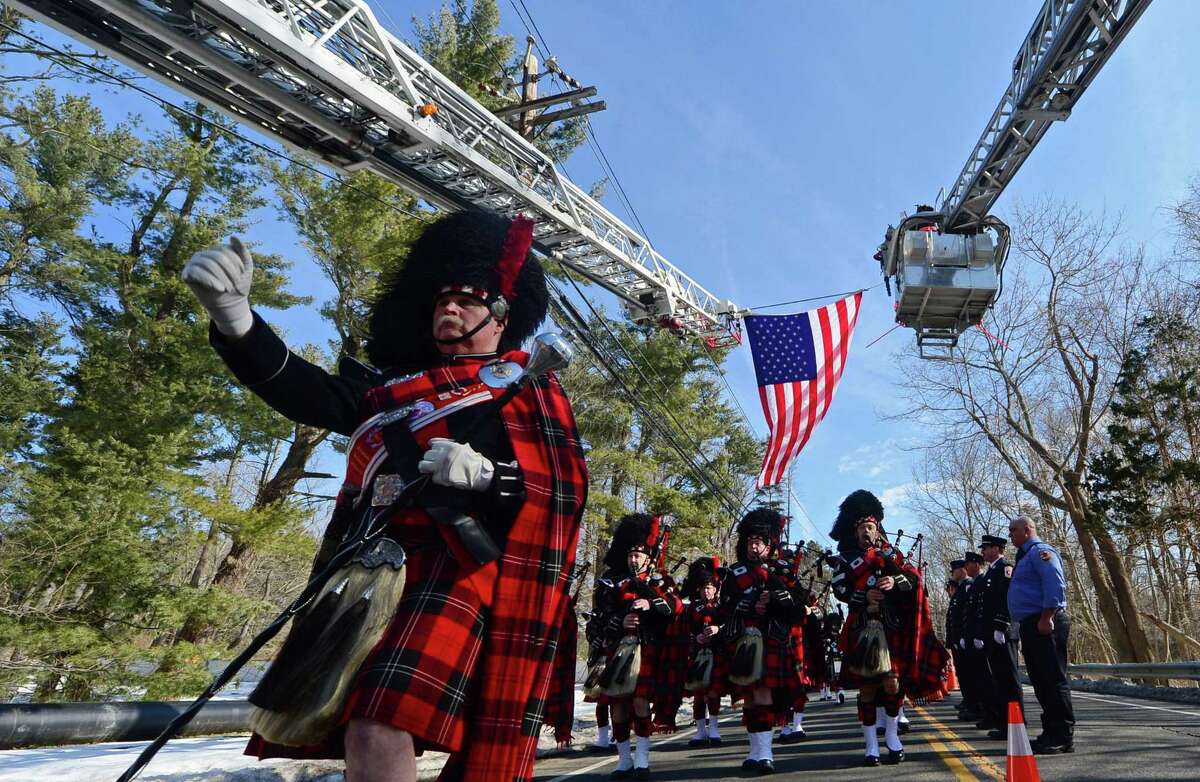 The Connecicut Firefighters Pipe and Drums honor Phil Reeves, a long time Wilton resident, U.S. Army veteran, and professional firefighter who served the Westport and Bridgeport communities, as they lead a funeral procession Saturday, February 18, 2017, outside at St. Matthew?’s Church on New Canaan Road, in Wilton, Conn.