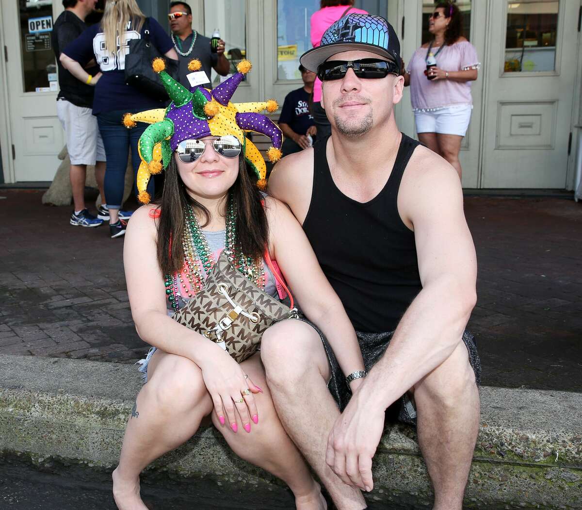 People pose for a photo at Mardi Gras! Galveston parade Sunday, Feb. 19, 2017, in Galveston.