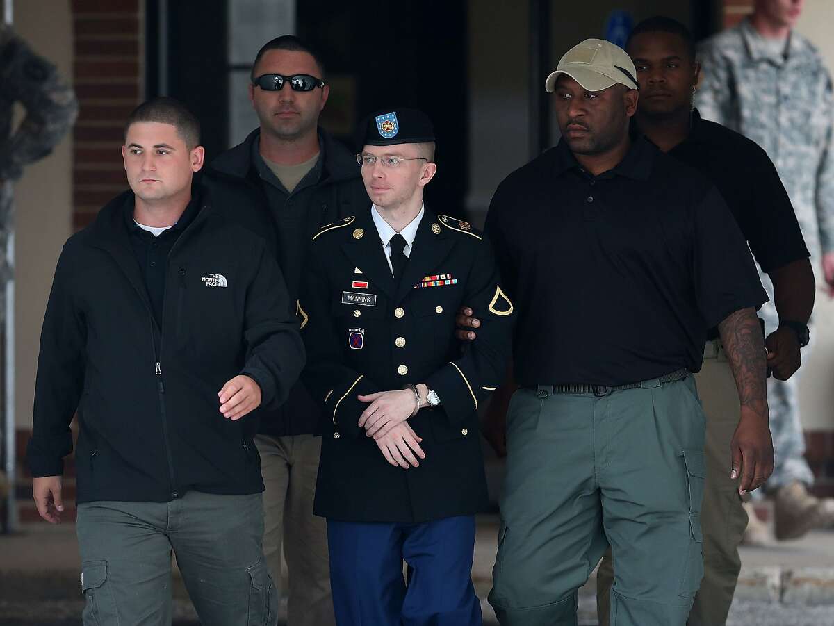File - JANUARY 17: President Obama commuted the sentence of Chelsea manning and is set to be freed on May 17th, rather than 2045. FORT MEADE, MD - AUGUST 20: US Army Private First Class Bradley Manning is escorted out of a military court facility?during the sentencing phase of his trial August 20, 2013 in Fort Meade, Maryland. Manning was found guilty of several counts under the Espionage Act, but acquitted of the most serious charge of aiding the enemy. (Photo by Mark Wilson/Getty Images)