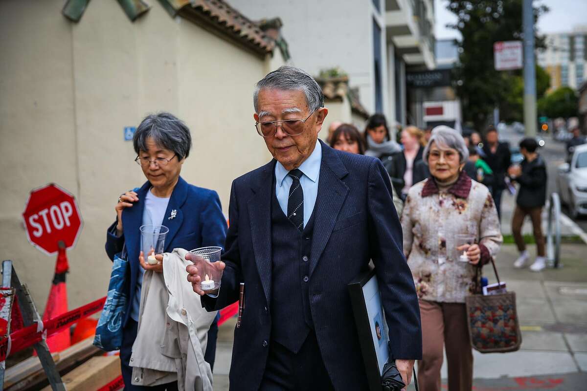 Ben Takeshita (left), who was honored with the Dr. Clifford I. Uyeda Peace and Humanitarian award, carries a plastic candle during a procession from the Kabuki Cinema to the Japanese Cultural Center during the Remembrance of the 75th anniversary of executive order 9066 in San Francisco, California, on Sunday, Feb. 19, 2017.