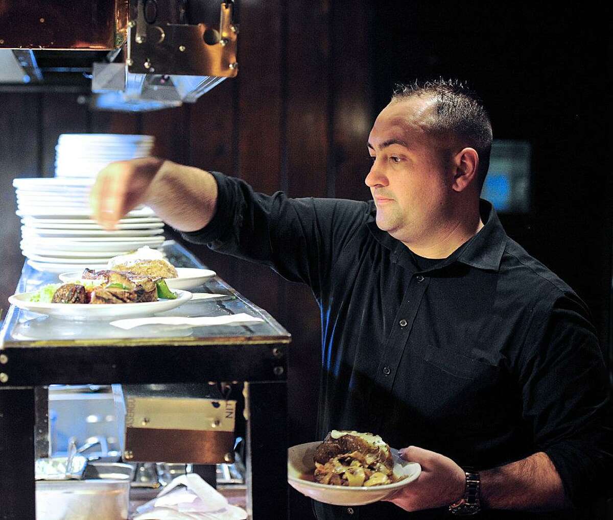 Waiter Douglas Makin picks up orders at Chuck's Steakhouse during Restaurant Week in Danbury in 2016.