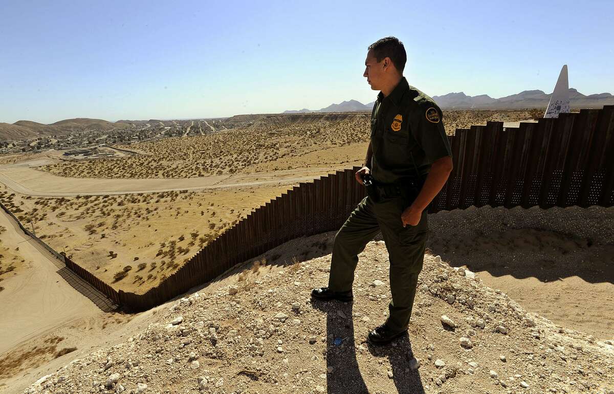 Border Patrol agent Joe Perez watches from a mesa near Sunland Park, New Mexico. Monument number 3 can be seen behind the fence at right in the photo. The fance is actually about three feet into U.S. territory. The border fence in the Border Patrol's El Paso sector is nearing completion. Feb. 19, 2009. BILLY CALZADA / gcalzada@express-news.net