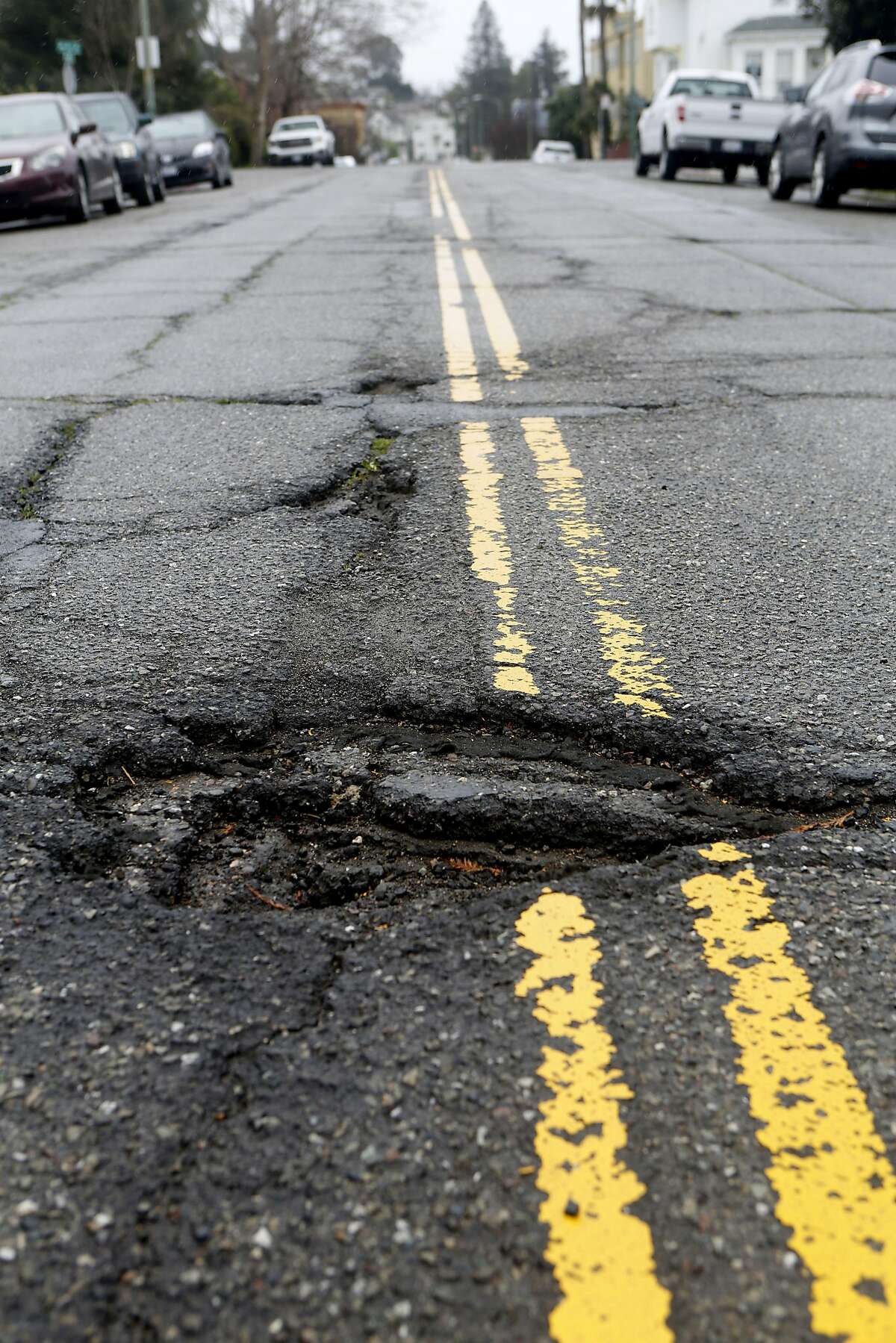 Two Oakland women painstakingly paint potholes