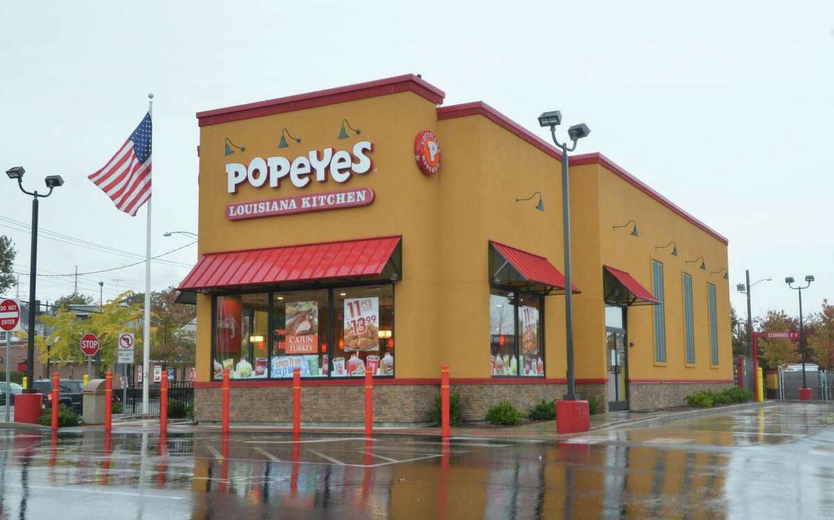 Restaurant Brands International says it’s buying Popeyes for $1.8 billion, bringing the chicken chain under the same corporate umbrella as Burger King and Tim Hortons.