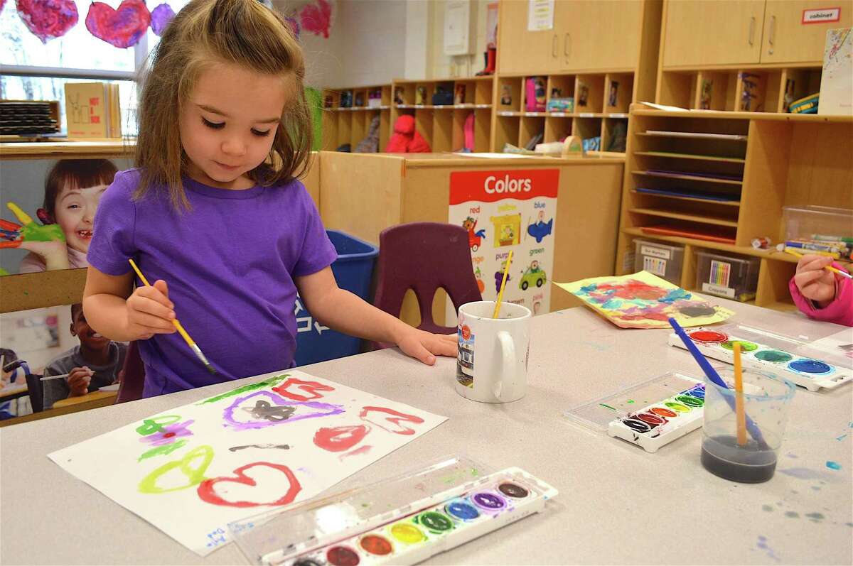 Ayla Martocci, 4, of Westport, paints a picture for her father at the Earthplace Vacation Drop-Off Program, Monday, Feb. 20, 2017, in Westport, Conn.