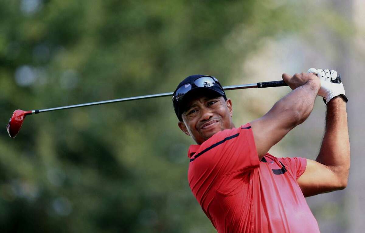 In this Feb. 2, 2014 file photo, Tiger Woods tees off at the 14th hole during the final round of the Dubai Desert Classic golf tournament in Dubai, United Arab Emirates. Woods hasn’t won a major since 2008.