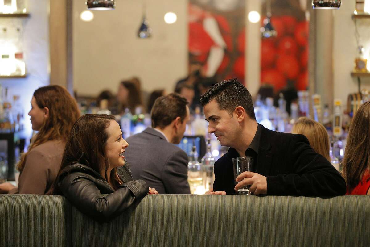 Jenn Collens, left, and Joe DeRose, right, chat during a Three Day Rule matchmaking event at LV Mar Restaurant in Redwood City, Calif., on Wednesday, February 8, 2017. The matchmaking service Three Day Rule launched a chapter in Silicon Valley, hoping to help techies too busy to find love make the right match.