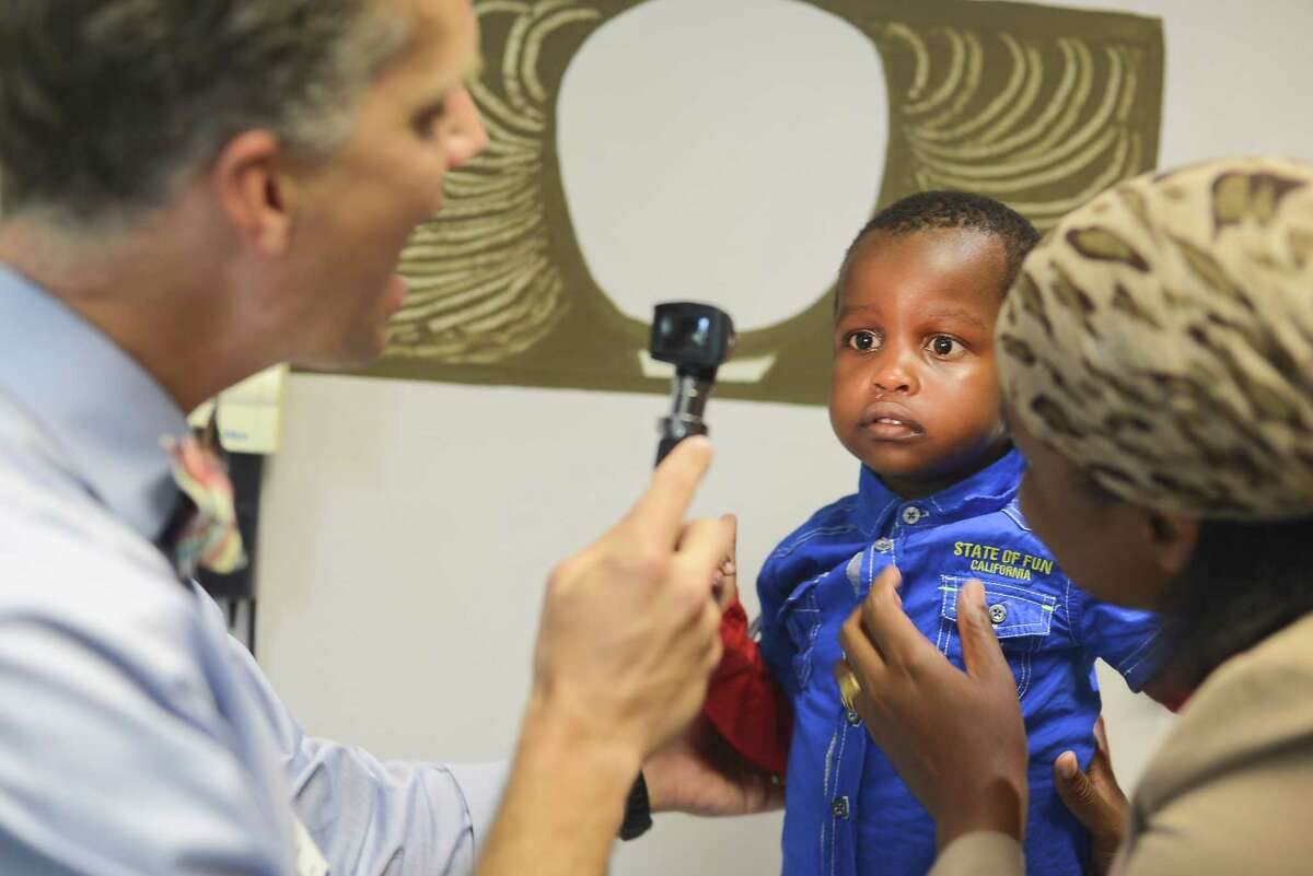 Dr. Alan Anderson talks to a patient and his mother. As part of the Global HOPE initiative, Baylor and Texas Children’s doctors hope to train 4,700 health care providers in several African nations.