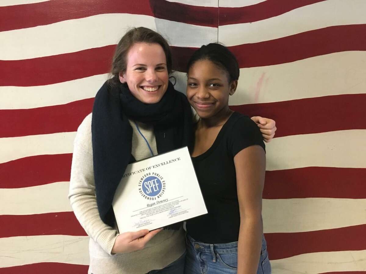 Regan Downey smiles with her mentee after receiving her Community Volunteer Award last week from the Stamford Public Education Foundation.