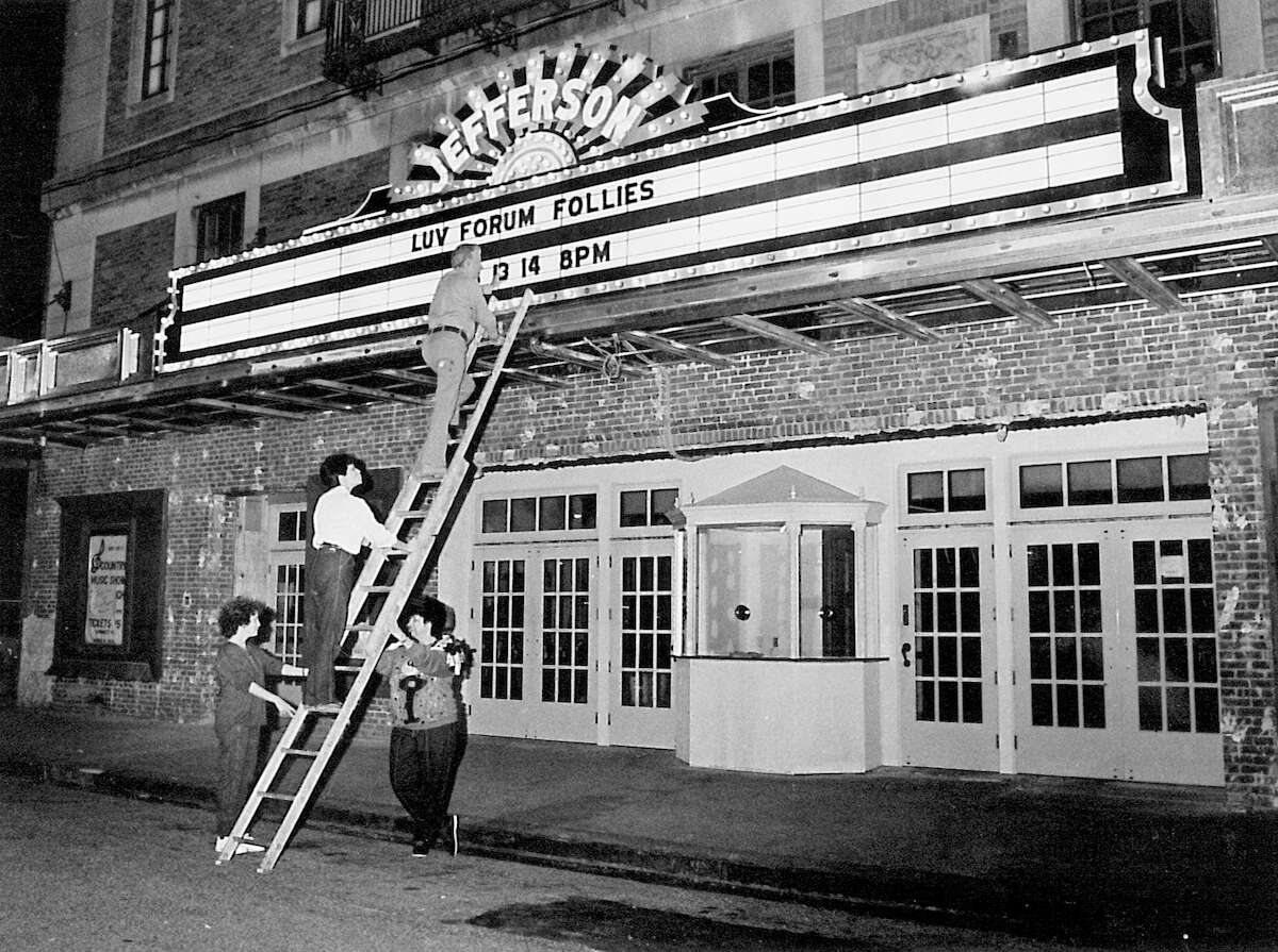 From left, Judy Railroad, Helga Lopez, Poogie Lindow and Walter Doiron add letters to the marque at the Jefferson Theatre on January 30, 1987. The marque had been newly renovated at the time. Enterprise archive photo