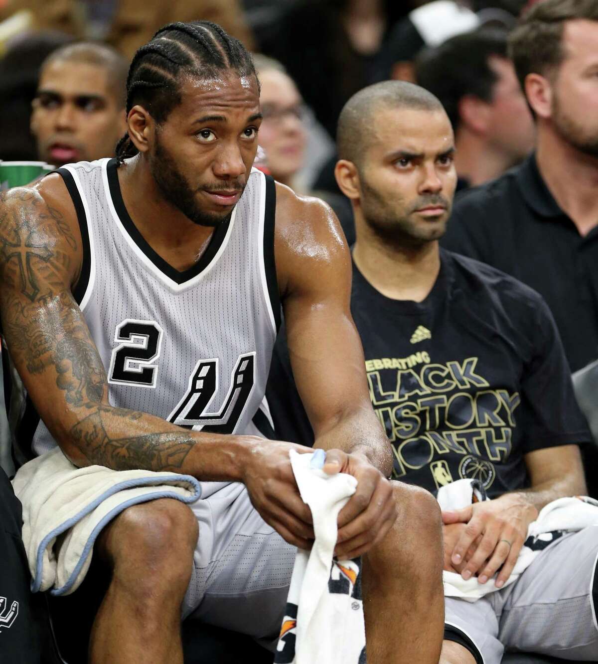 San Antonio Spurs' Kawhi Leonard and Tony Parker watch action against the Denver Nuggets from the bench Saturday Feb. 4, 2017 at the AT&T Center.