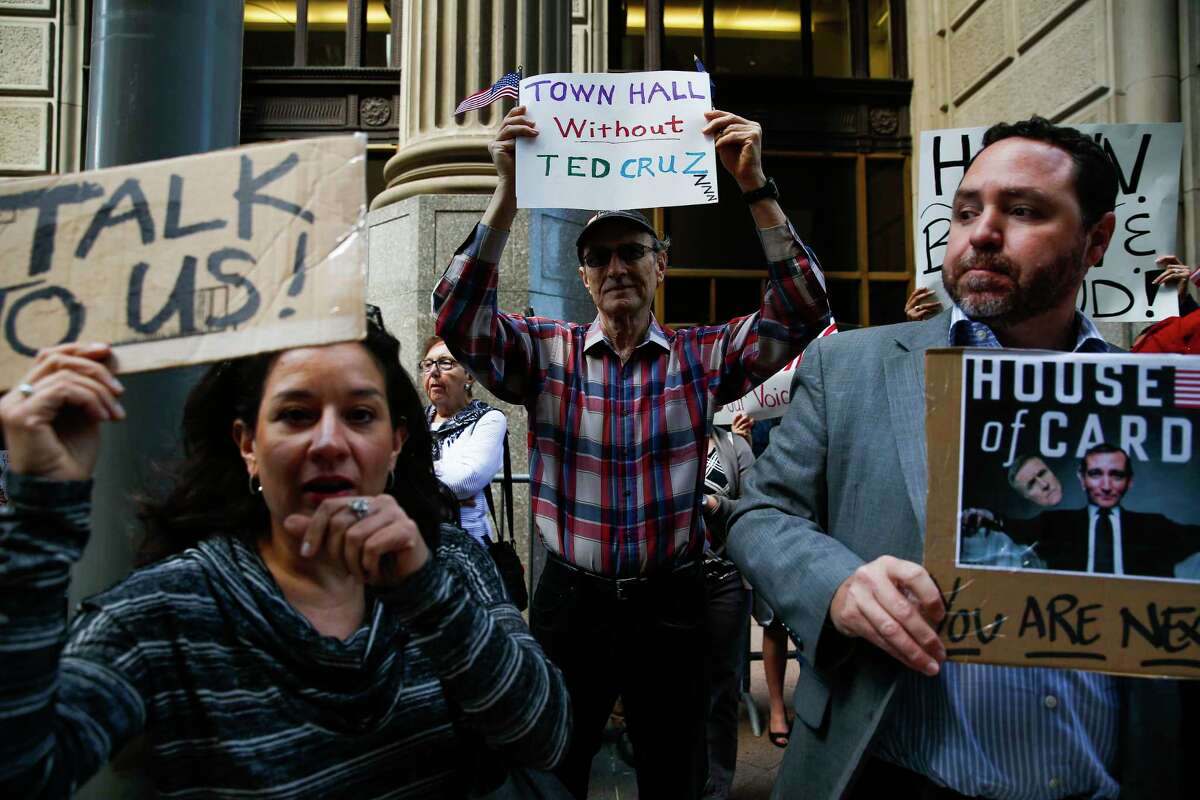 Eric Eubanks, center, joins with other protestors as they hold a "Town Hall Without Ted Cruz" outside Cruz's office in downtown Houston Tuesday, Feb. 21, 2017. The protest is a response to Cruz's apparent refusal to meet with constituents or hold a Town Hall during the February recess. A small group of protestors were allowed up to speak with senior members of Cruz's staff.