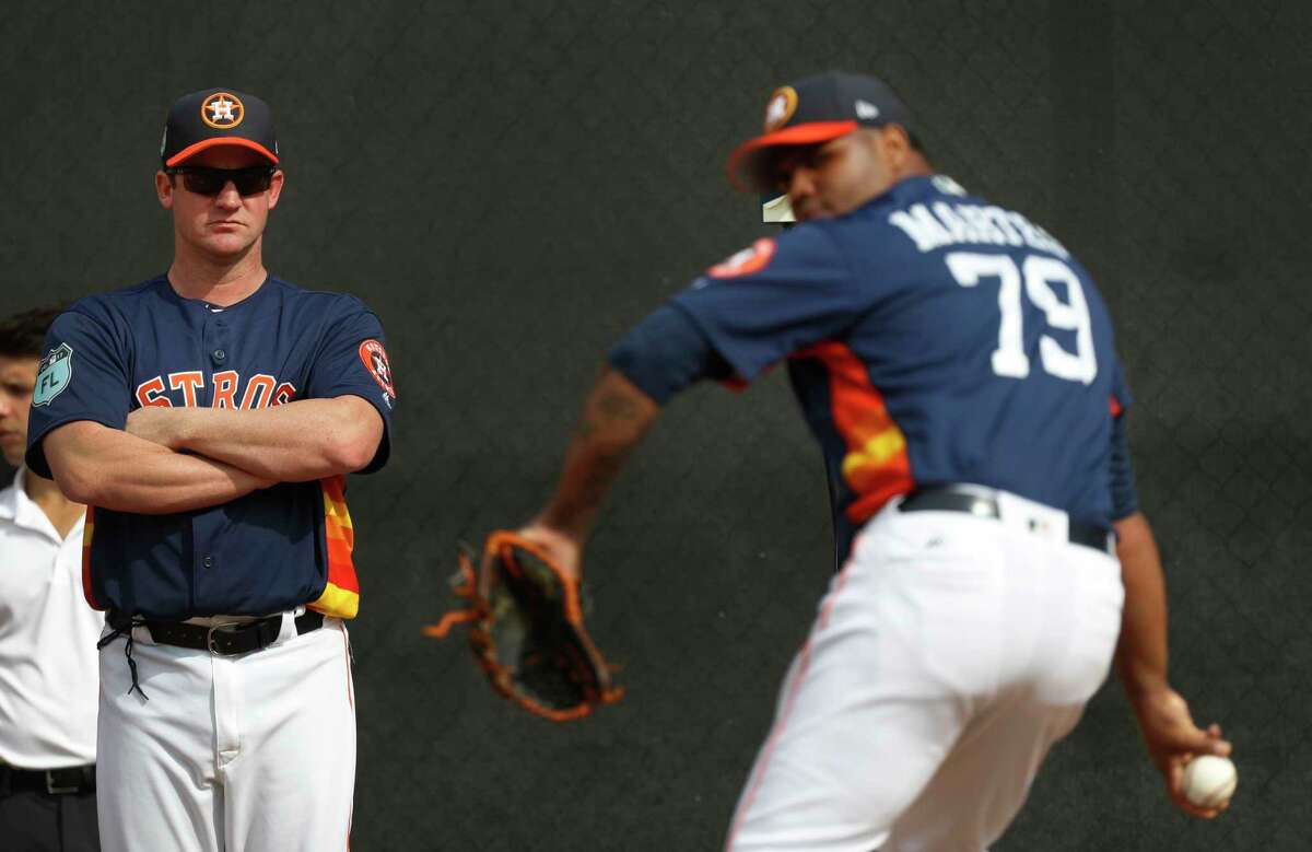 Former Houston Astros pitcher Roy Oswalt watches pitcher Francis Martes (79) throw during spring training at The Ballpark of the Palm Beaches, in West Palm Beach, Florida, Tuesday, February 21, 2017.