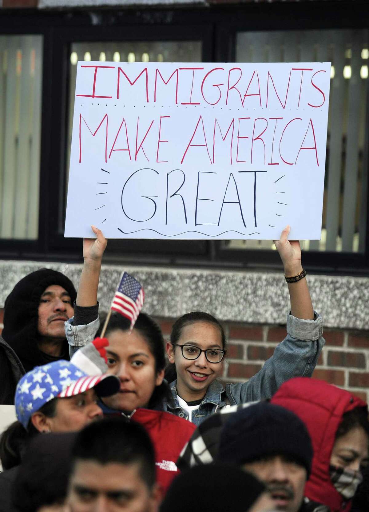 Gabby Perez, 17, of Danbury, holds a "Immigrants make America great" sign at a "Day without immigrants" rally at the Danbury City Hall Thursday, February 16, 2017.
