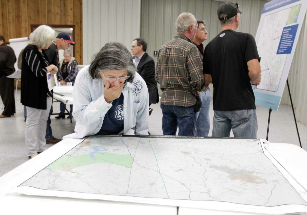 Bertha Sustaita of Shiro looks at a map while attending a public meeting on Dec. 4, 2014, in Navasota at the Grimes County Expo Center about the proposed high-speed rail project from Dallas to Houston.