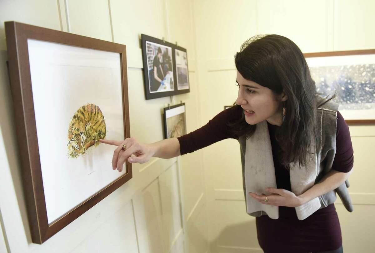 Sacred Heart alumna Genevieve Irwin shows her monotype painting of a Siberian tiger cub at the exhibition of her work displayed at Sacred Heart Greenwich in Greenwich, Conn. Tuesday, Feb. 21, 2017. Irwin is working on a collection of monotype paintings for a children's book about Siberian tigers while completing her MFA in Illustration at the School of Visual Arts in New York.