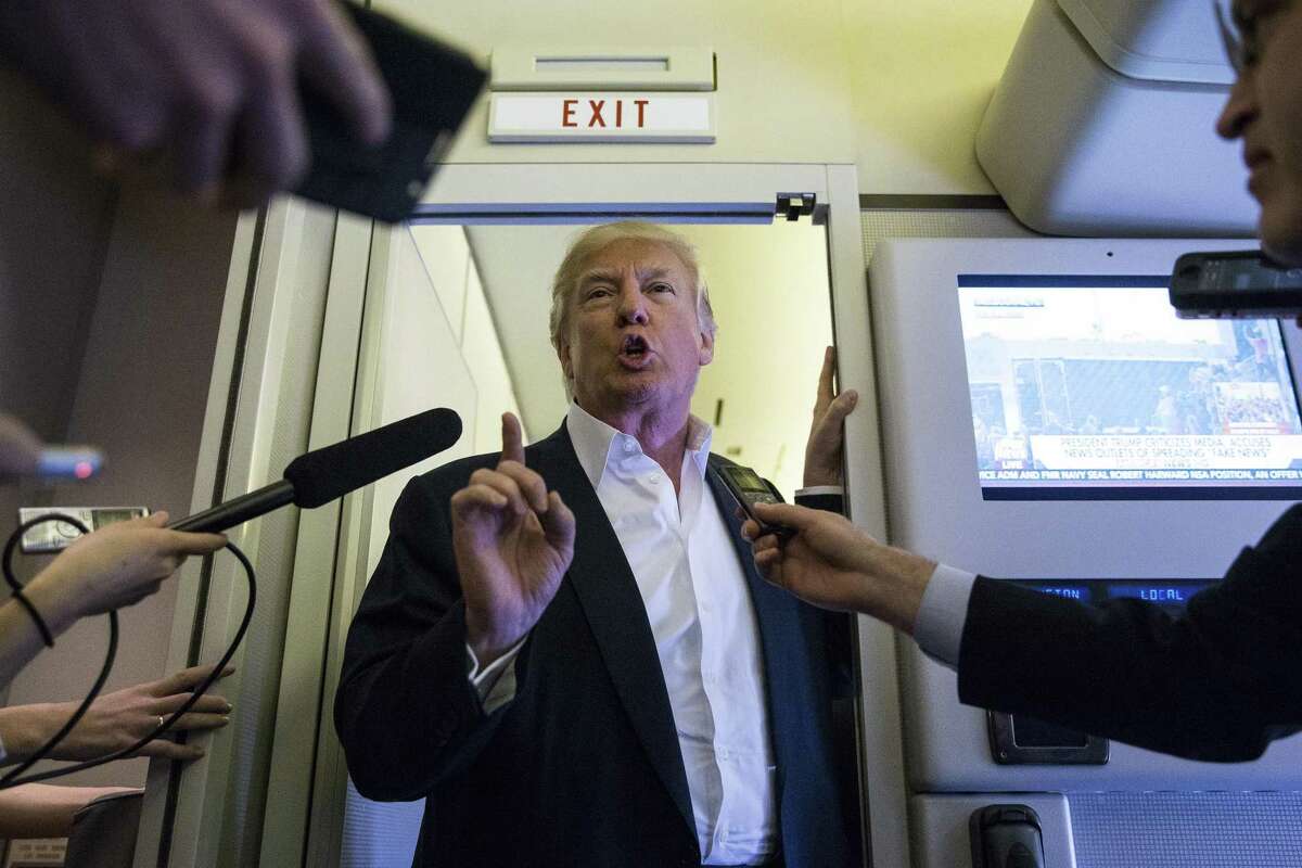 President Donald Trump speaks with reporters in the press cabin of Air Force One before a rally at Orlando Melbourne International Airport, in Melbourne, Fla., Feb. 18, 2017. (Al Drago/The New York Times)