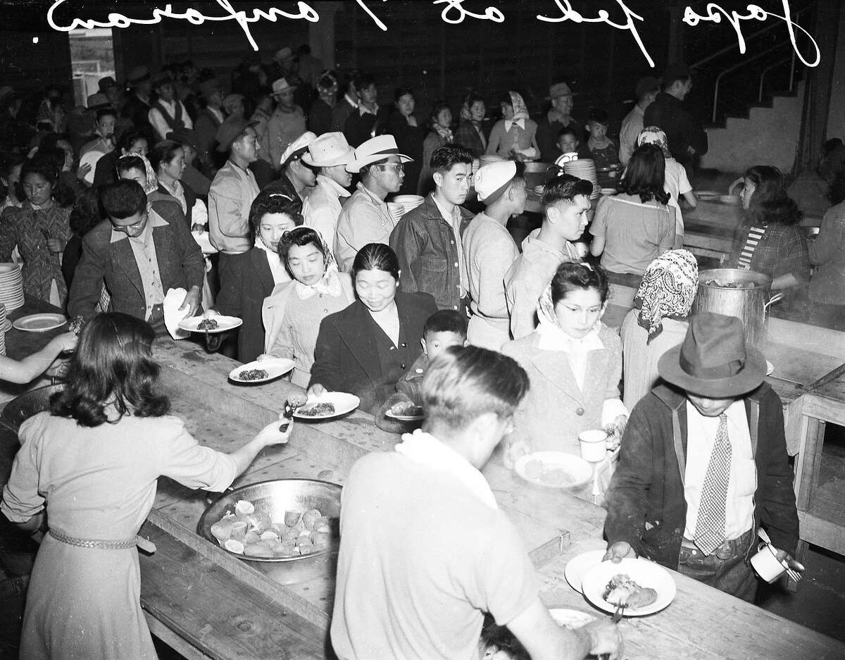 In September of 1942, California citizens of Japanese descent eat one of their last meals at Tanforan Park, before boarding a train from the Bay Area internment camp to another camp in Utah.